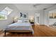 Bright bedroom boasts hardwood floors, white walls, a ceiling fan, and ample natural light at 3816 Dover Rd, Durham, NC 27707