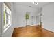 Bright bedroom with hardwood floors, and open shelving, and large window with exterior view at 3816 Dover Rd, Durham, NC 27707