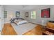Well-lit bedroom with hardwood floors, area rug, and sports memorabilia at 3816 Dover Rd, Durham, NC 27707