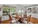 Bright dining area with built-in shelving, a round table, and large windows, ideal for Gathering meals at 3816 Dover Rd, Durham, NC 27707