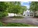 Circular driveway with a trampoline and views of the house, garage, and covered patio at 3816 Dover Rd, Durham, NC 27707