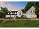 Beautiful front exterior of a grand home at sunset with meticulous landscaping at 3816 Dover Rd, Durham, NC 27707