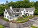 Beautiful white home featuring lush landscaping and a circular driveway at 3816 Dover Rd, Durham, NC 27707