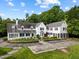 Aerial view of a grand white home featuring manicured grounds, a stone driveway, and mature trees, highlighting its estate setting at 3816 Dover Rd, Durham, NC 27707