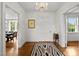 Bright foyer with hardwood floors, a chandelier, and neutral decor, creating a welcoming and elegant entrance at 3816 Dover Rd, Durham, NC 27707