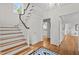 Elegant foyer features hardwood floors, staircase, chandelier, and arched doorways, creating a welcoming entrance at 3816 Dover Rd, Durham, NC 27707
