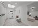Welcoming foyer with a skylight, bench seating, and coat hooks, seamlessly connecting to a cozy living area at 3816 Dover Rd, Durham, NC 27707