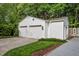 Spacious two-car garage with white brick exterior and well-maintained landscaping at 3816 Dover Rd, Durham, NC 27707