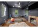 Home gym with exercise equipment, a mirror wall, and a brick fireplace, providing a dedicated workout space at 3816 Dover Rd, Durham, NC 27707