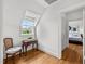 Cozy hallway with chair, table, and natural light from the window, leading to a bedroom at 3816 Dover Rd, Durham, NC 27707