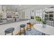 Spacious kitchen with a center island and barstool seating, plus access to an outdoor patio via a glass-paneled door at 3816 Dover Rd, Durham, NC 27707
