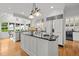 Bright kitchen showcases a large island, stainless steel appliances, and a convenient beverage center for seamless entertaining at 3816 Dover Rd, Durham, NC 27707