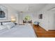 Relaxing bedroom featuring hardwood floors, a ceiling fan, and an open sitting area at 3816 Dover Rd, Durham, NC 27707