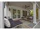 Covered stone patio with outdoor seating and a ceiling fan for comfortable relaxation at 3816 Dover Rd, Durham, NC 27707