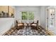 Comfortable sitting area with two chairs, a small table, and a graphic rug with a large window at 3816 Dover Rd, Durham, NC 27707
