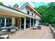 Spacious back deck offering comfortable seating, barbecue, and outdoor dining space with wooded views at 382 Valley Ln, Pittsboro, NC 27312