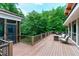 Large deck with outdoor seating surrounded by lush trees at 382 Valley Ln, Pittsboro, NC 27312