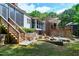 Backyard with deck, stairs, outdoor bench, and stone accent at 382 Valley Ln, Pittsboro, NC 27312