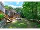 Backyard with deck, stairs, outdoor bench, and stone accent at 382 Valley Ln, Pittsboro, NC 27312