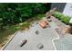 Overhead view of landscaped backyard with gravel patio and a wooden bench seating area at 382 Valley Ln, Pittsboro, NC 27312