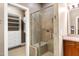 Bathroom with glass enclosed shower and view into a walk-in closet with shelving at 382 Valley Ln, Pittsboro, NC 27312