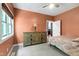 Bedroom area with a decorative chest of drawers with a lamp, ceiling fan, and window at 382 Valley Ln, Pittsboro, NC 27312