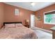 Comfortable bedroom with decorative bedspread, ceiling fan, and window with a view at 382 Valley Ln, Pittsboro, NC 27312