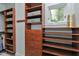 Walk-in closet featuring custom wood shelving, drawers, and natural light from window at 382 Valley Ln, Pittsboro, NC 27312