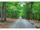 Gravel driveway through a heavily wooded area at 382 Valley Ln, Pittsboro, NC 27312