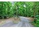 Long gravel driveway leading up to the home through a wooded area at 382 Valley Ln, Pittsboro, NC 27312