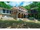 Charming exterior featuring a deck, stone accents, and a lush green lawn for outdoor enjoyment at 382 Valley Ln, Pittsboro, NC 27312
