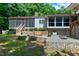 Backyard view features stone walls, a wooden bench, and a screen porch at 382 Valley Ln, Pittsboro, NC 27312