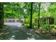 Exterior view of home with garage and screened-in porch surrounded by trees at 382 Valley Ln, Pittsboro, NC 27312