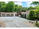 Wide driveway leading to a home with a multi-car garage and unique design, framed by lush greenery at 382 Valley Ln, Pittsboro, NC 27312