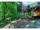 The backyard offers a wooded landscape featuring a gazebo, stairs, and brickwork at 382 Valley Ln, Pittsboro, NC 27312