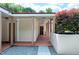 A well-lit entrance to a home stands with stone pavers and an ornamental tree for privacy at 382 Valley Ln, Pittsboro, NC 27312