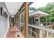 Long hallway with wood floors and large windows overlooking the deck and wooded yard at 382 Valley Ln, Pittsboro, NC 27312