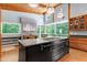 Stylish kitchen features a black center island with cooktop and stainless steel appliances at 382 Valley Ln, Pittsboro, NC 27312
