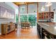 Open kitchen features a breakfast nook, custom cabinetry, and views of nature at 382 Valley Ln, Pittsboro, NC 27312