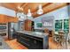 A spacious kitchen featuring an island cooktop, stainless steel appliances, and wood ceiling at 382 Valley Ln, Pittsboro, NC 27312