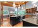 Spacious kitchen with a center island, stainless steel appliances, and scenic backyard views at 382 Valley Ln, Pittsboro, NC 27312
