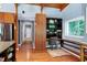 Open kitchen area with hardwood floors, desk, and stainless steel appliances at 382 Valley Ln, Pittsboro, NC 27312