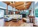 An expansive living room with wood ceiling, hardwood floors and modern furnishings at 382 Valley Ln, Pittsboro, NC 27312