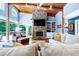 A bright and airy living room with stone fireplace, wood ceilings and modern furnishings at 382 Valley Ln, Pittsboro, NC 27312
