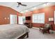 This bedroom includes vaulted ceilings, a seating area, television, and access to ensuite bathroom at 382 Valley Ln, Pittsboro, NC 27312