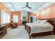 Spacious main bedroom features a fireplace, ceiling fan, a cozy seating area, and a large bed at 382 Valley Ln, Pittsboro, NC 27312