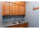 Mud room area featuring wooden cabinets and a countertop with a stainless steel sink at 382 Valley Ln, Pittsboro, NC 27312