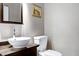 A half-bathroom features a stylish bowl sink, modern faucet, and contemporary mirror at 382 Valley Ln, Pittsboro, NC 27312