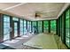 Sun room boasts floor to ceiling windows and skylights with retractable pool cover and exercise equipment at 382 Valley Ln, Pittsboro, NC 27312