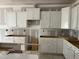 Bright kitchen featuring crisp, white cabinetry, new construction and spacious layout perfect for customization at 3920 Well Fleet Dr, Fuquay Varina, NC 27526